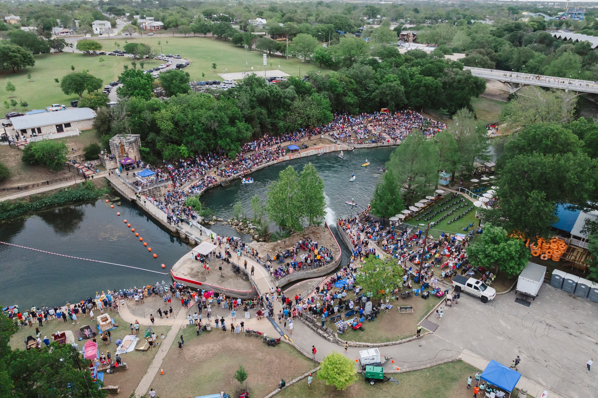 Aerial view of Thru the Chute event showing the full scale of the crowd along the Comal River